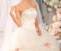 Vestito da sposa con rose in tessuto applicate sulla gonna
