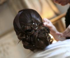 Acconciatura bassa raccolta con applicazione di brillantini