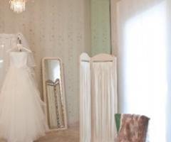 Vestito da sposa in mostra nel salotto dell'atelier