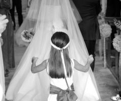 La damigella sorregge il velo della sposa