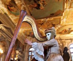 Musicista con arpa in maschera