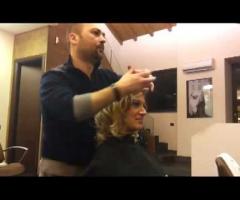 Roberto System al lavoro, mentre realizza un'acconciatura sposa