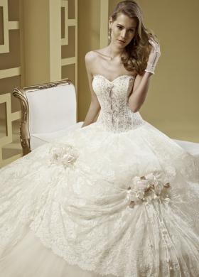 Abito da sposa con bustino stretto e fiori applicati sulla gonna